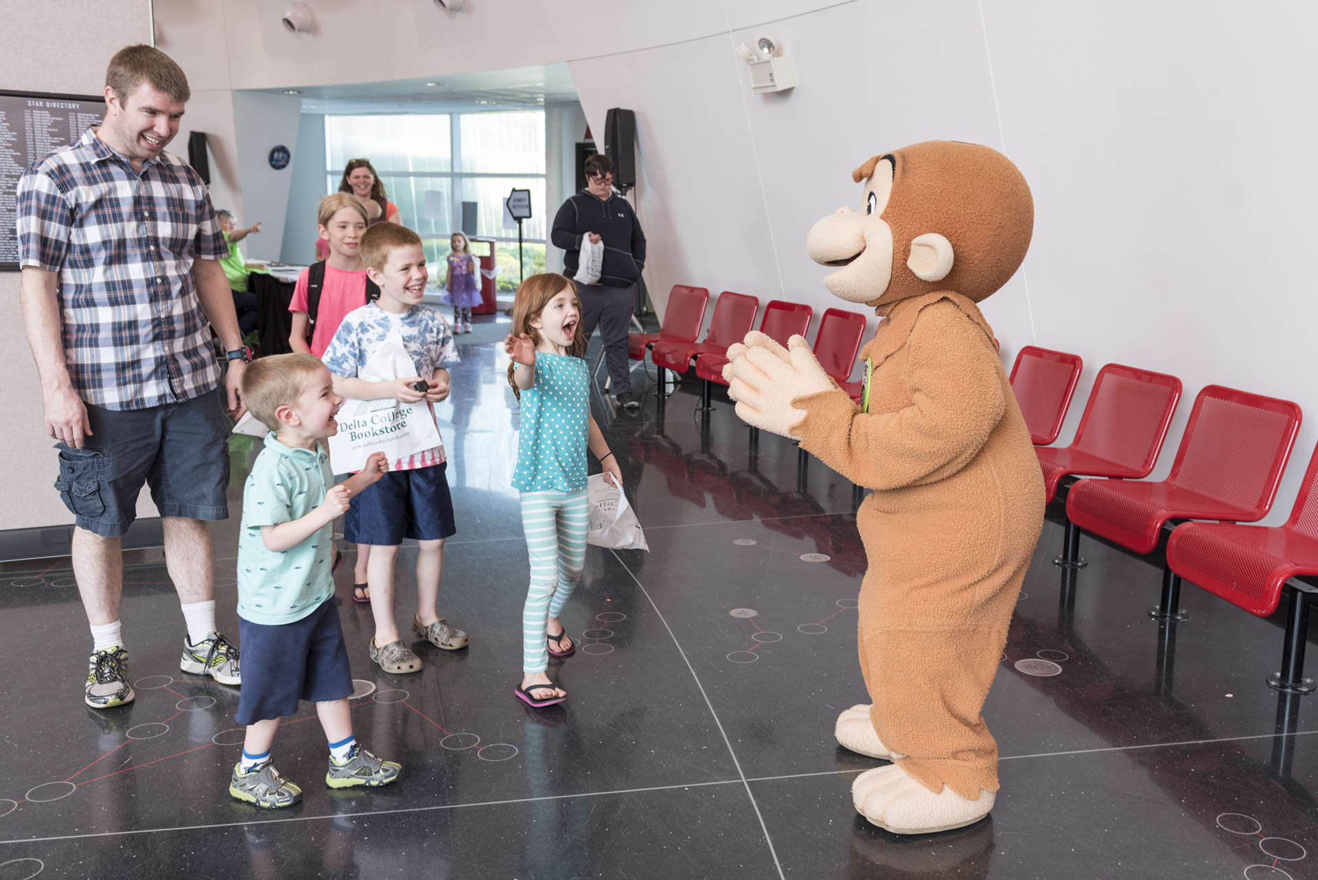 Children with Curious George at the open house