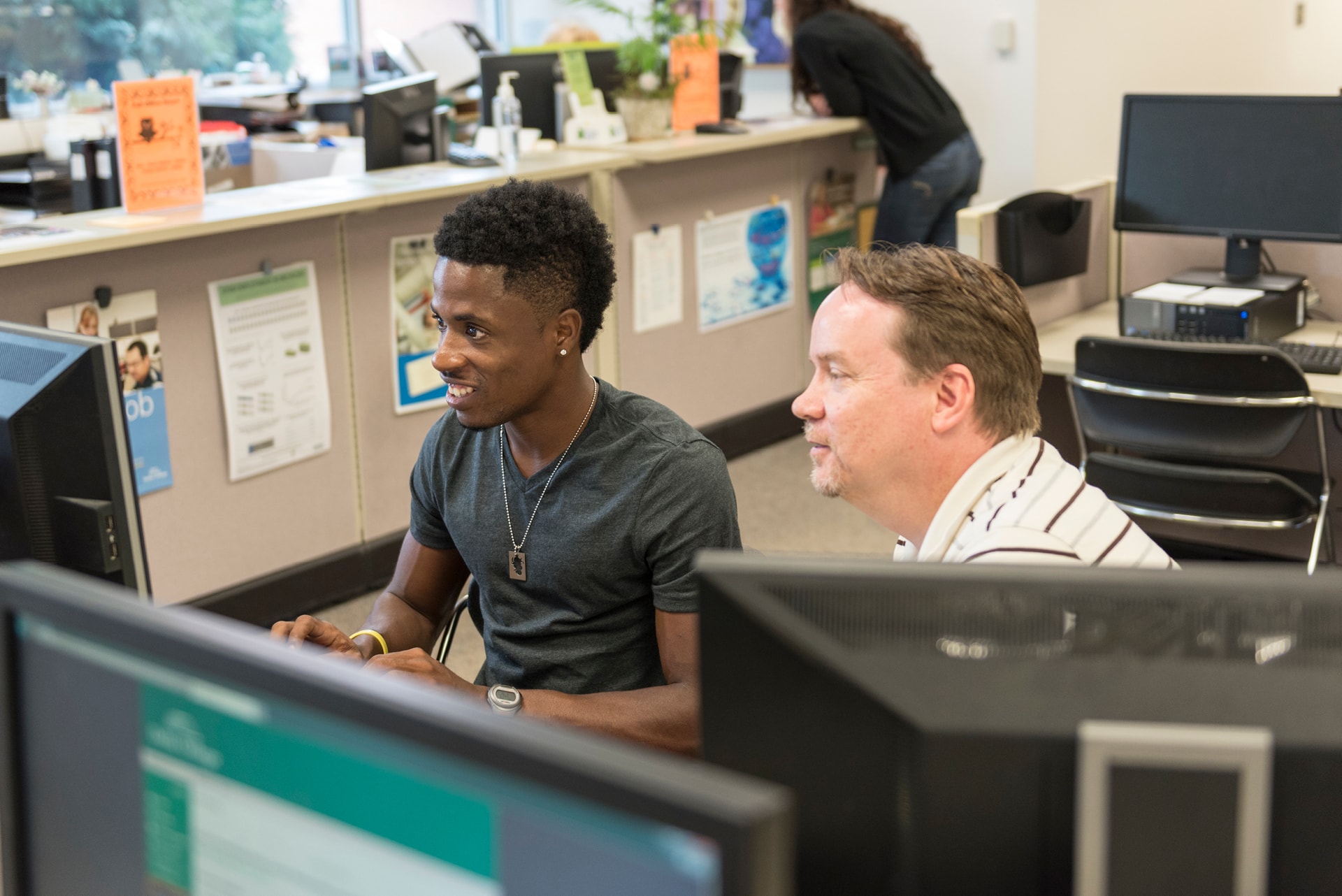 Student working on computer with an advisor