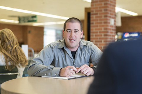 Big Thinker - Dustin Robinson Dusting working at a table