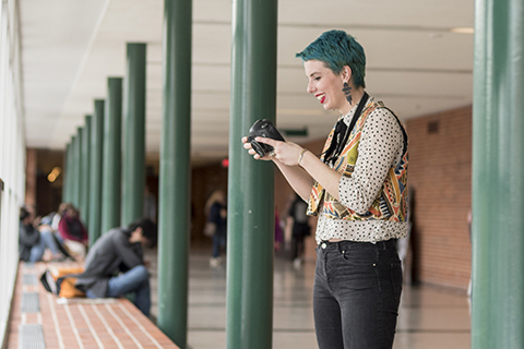 Josie with her camera in Delta's halls.