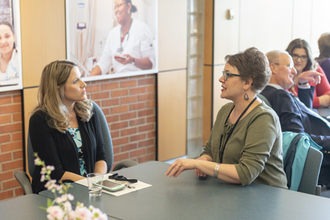 Big Thinker - Kimberly Wegrzyn Kimberly speaking with a faculty member in a meeting