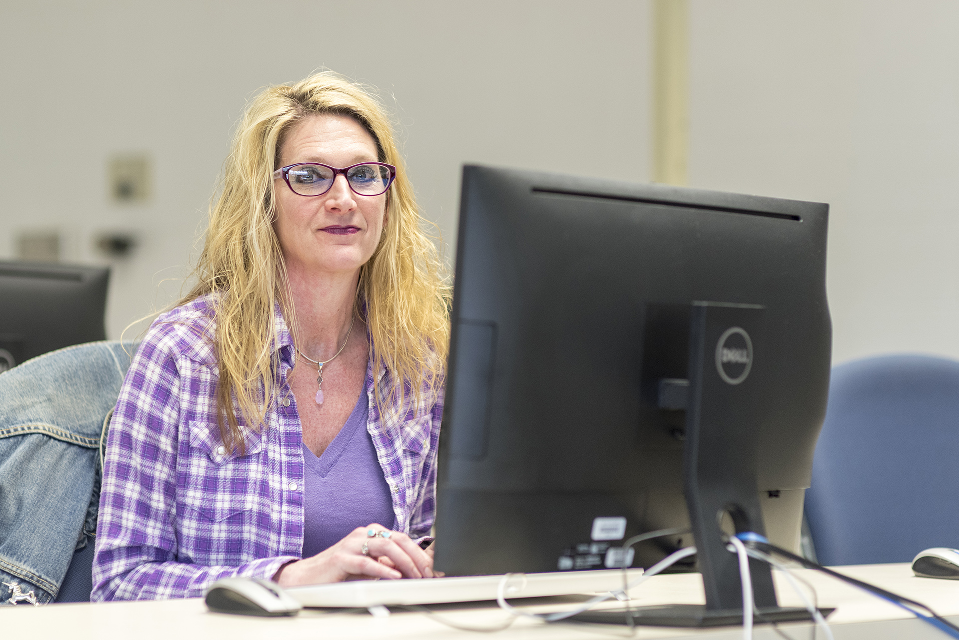 Sandi sitting at a computer