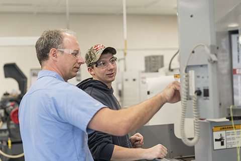 Big Thinker - Terry Morse Terry Morse working with a student in Delta's CNC lab