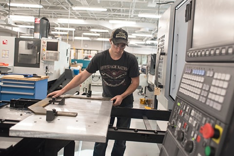 Student working on CNC equipment