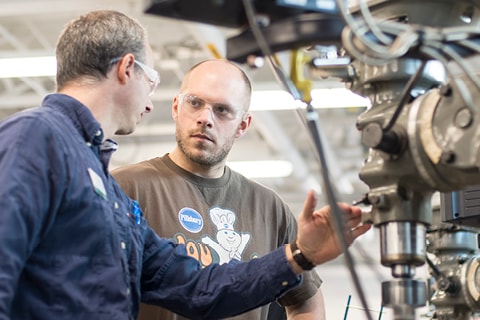 CNC instructor and student working in lab