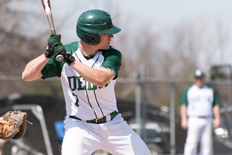 Delta Baseball team member at bat