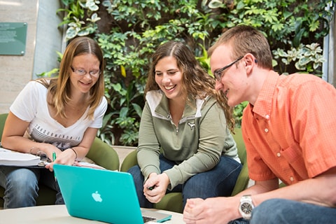 Students gathered around laptop