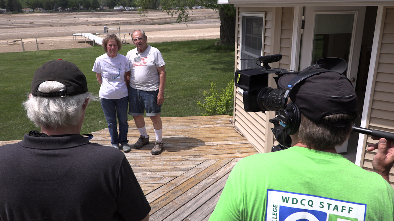 Photo of producers interviewing people affected by the flooding.