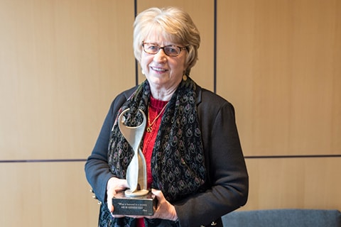 Dr. Goodnow holding the Athena award