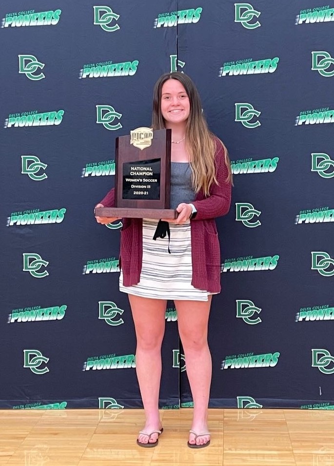 Elizabeth Green holding her award plaque. 