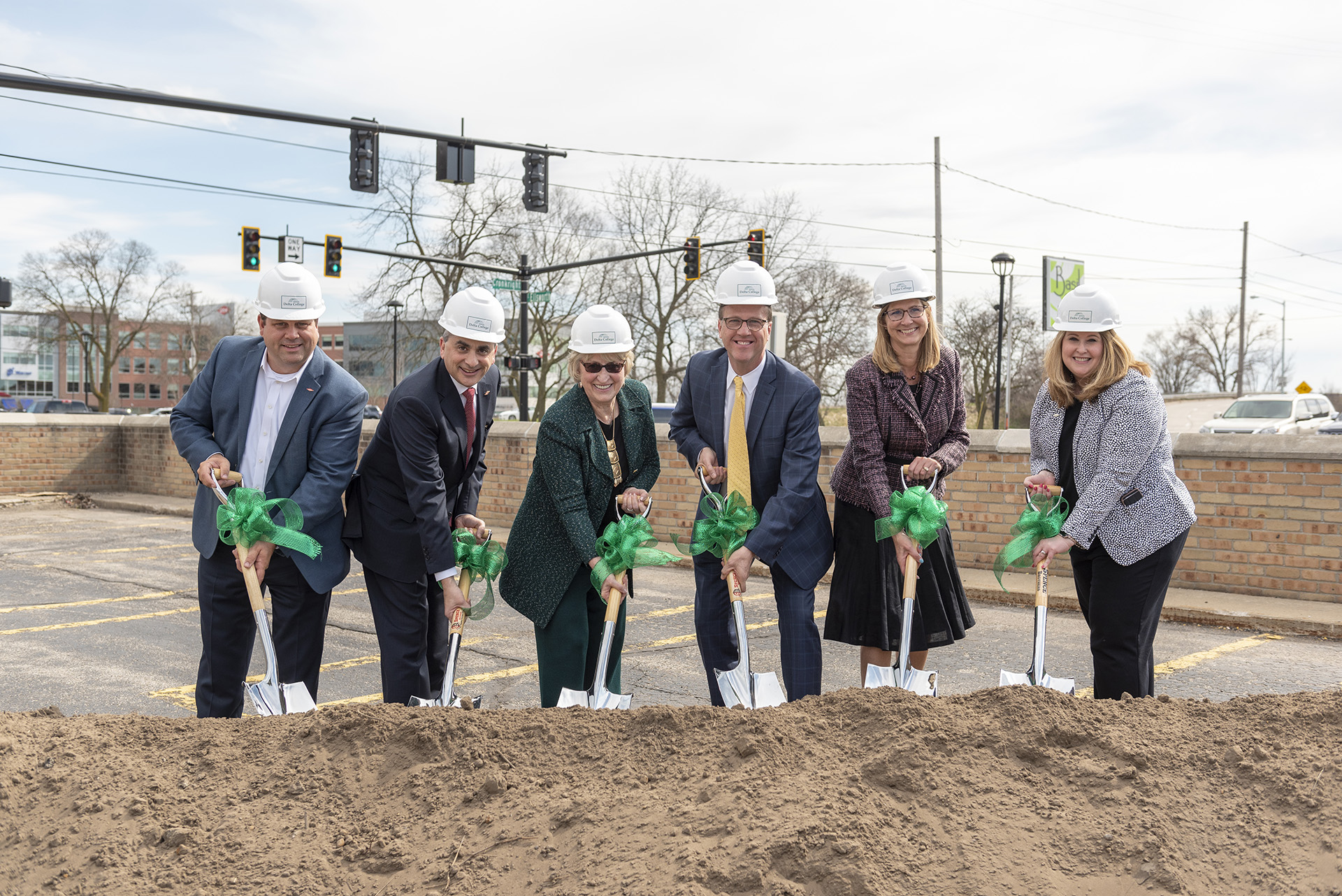 Group of administrators with shovels at groundbreaking