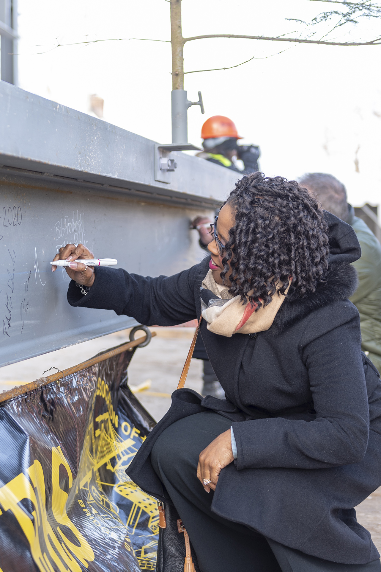 Board member signing the beam