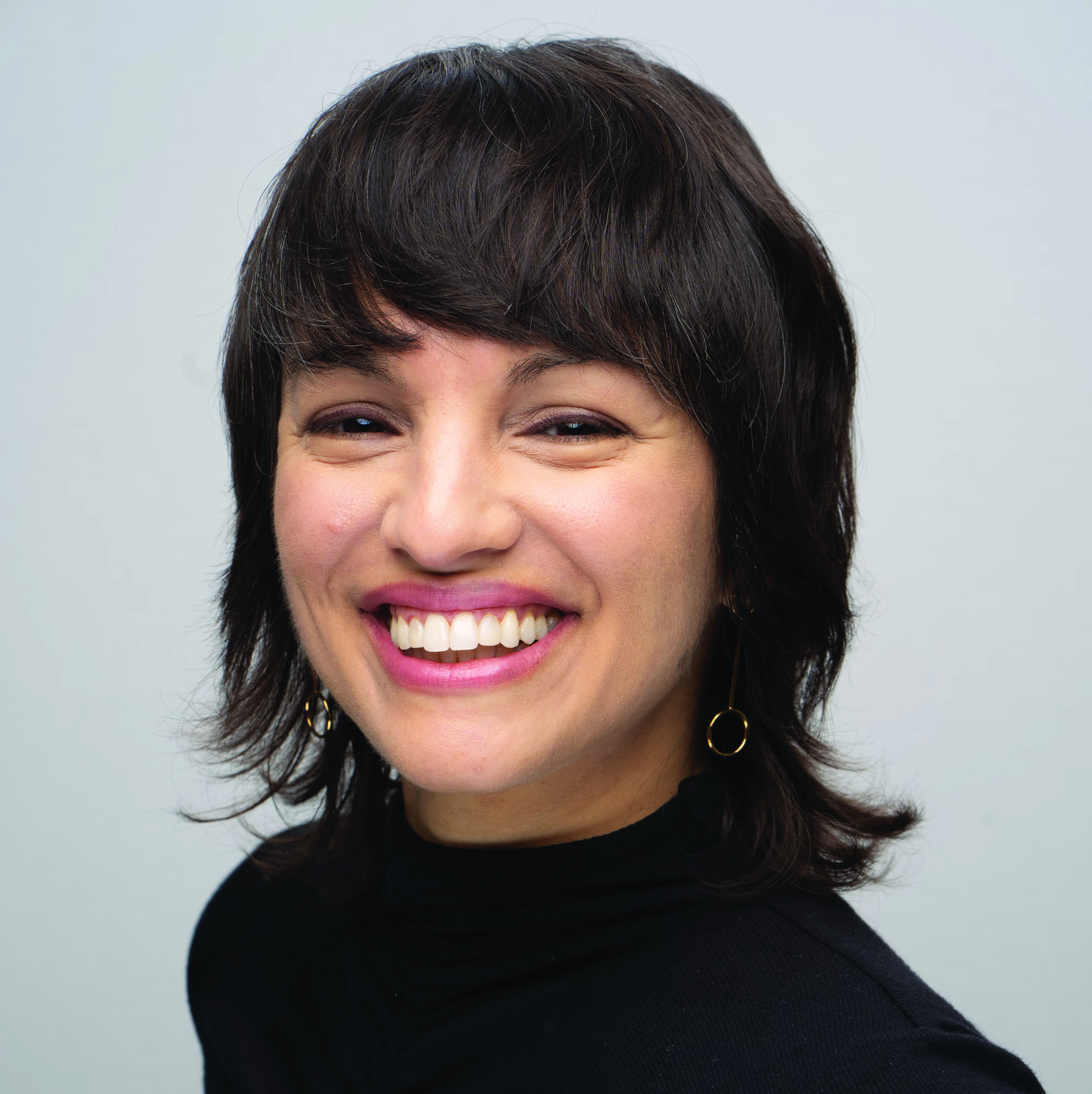 Mónica Guzmán smiling in professional headshot