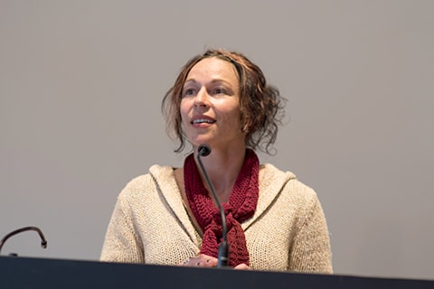 Crystal Starky speaking at a podium