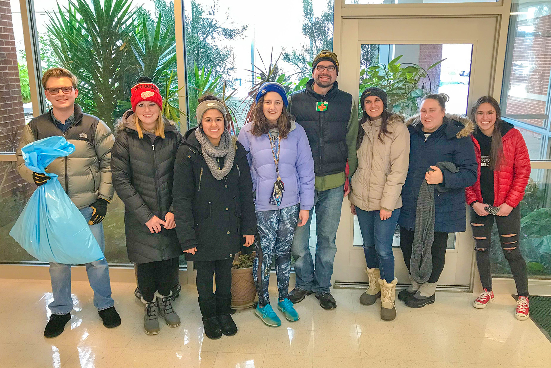 Group shot of the Environmental Club by the Delta Conservatory