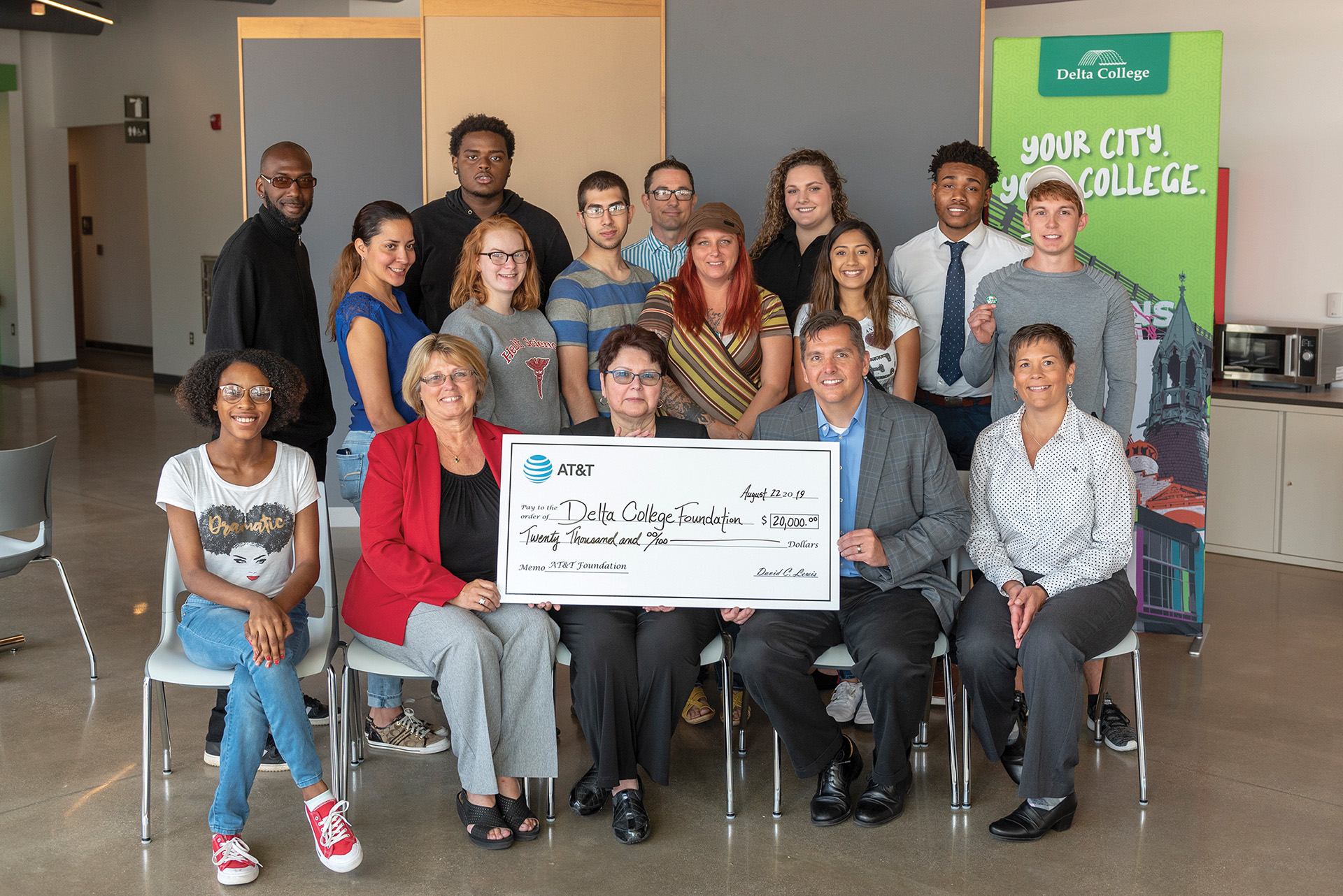 Students and staff with donation check