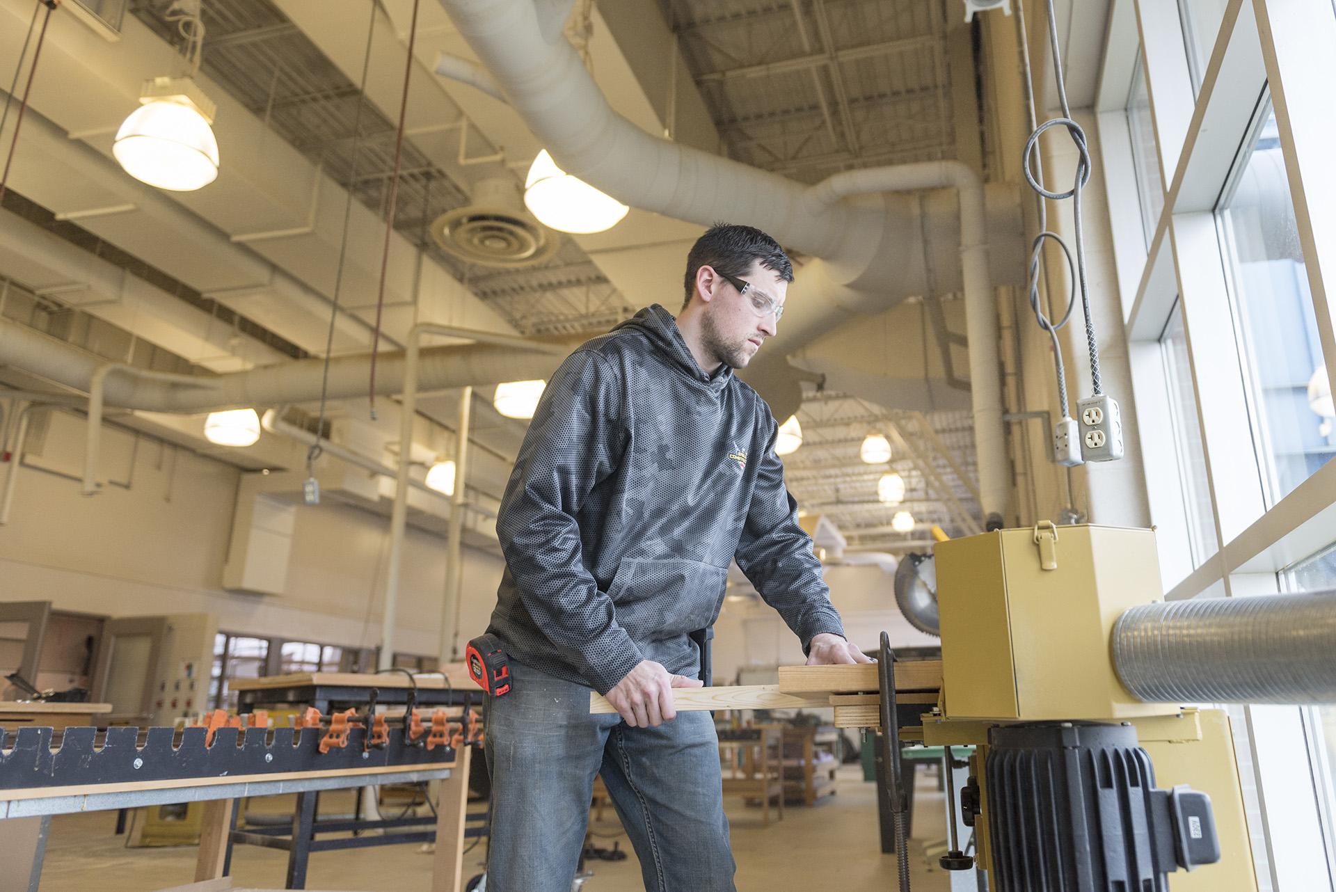 A student in the construction lab gets hands-on training and practice.