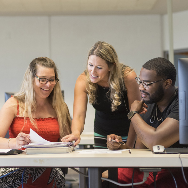 OAT instructor with two students in computer lab