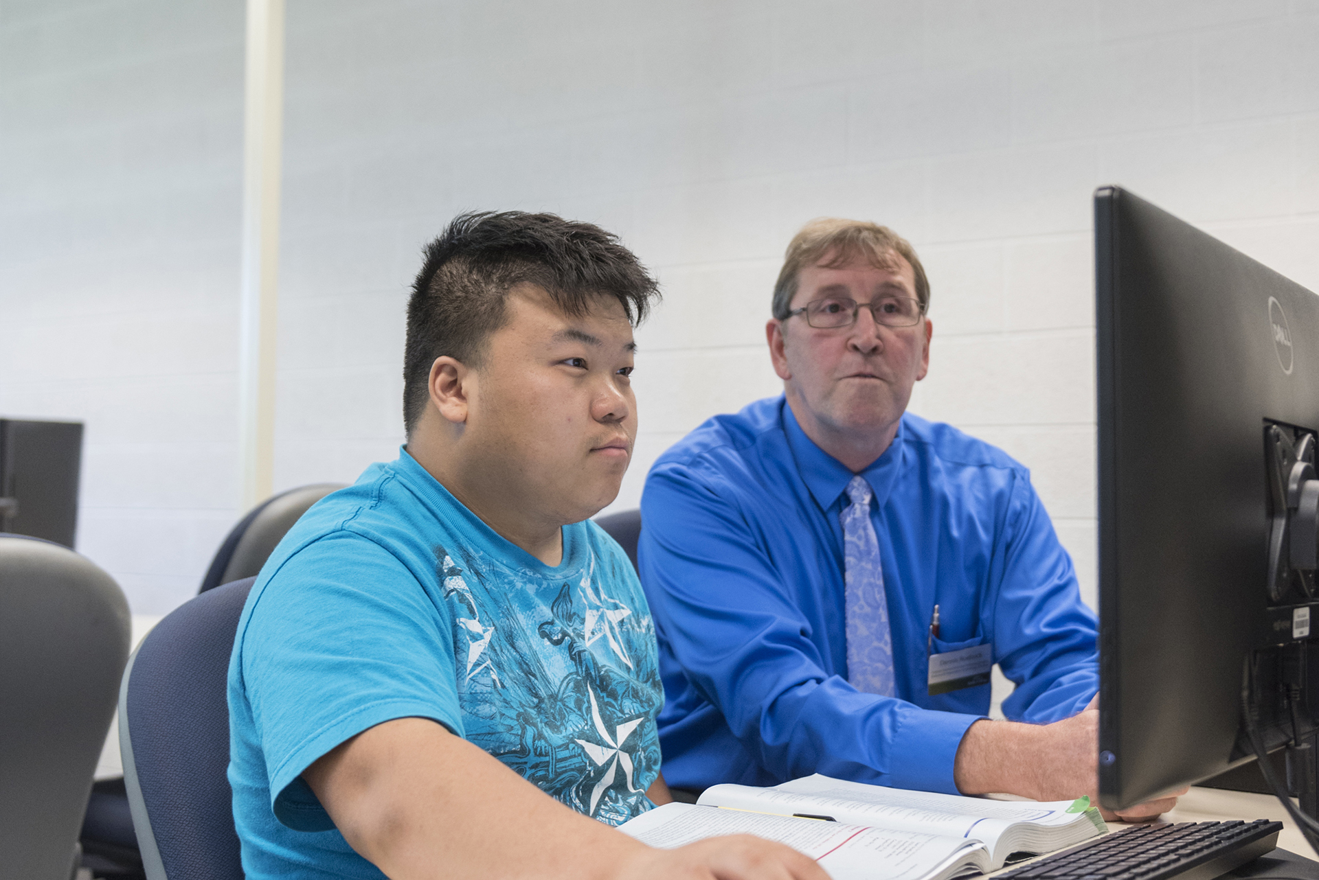 Student and instructor working in computer lab