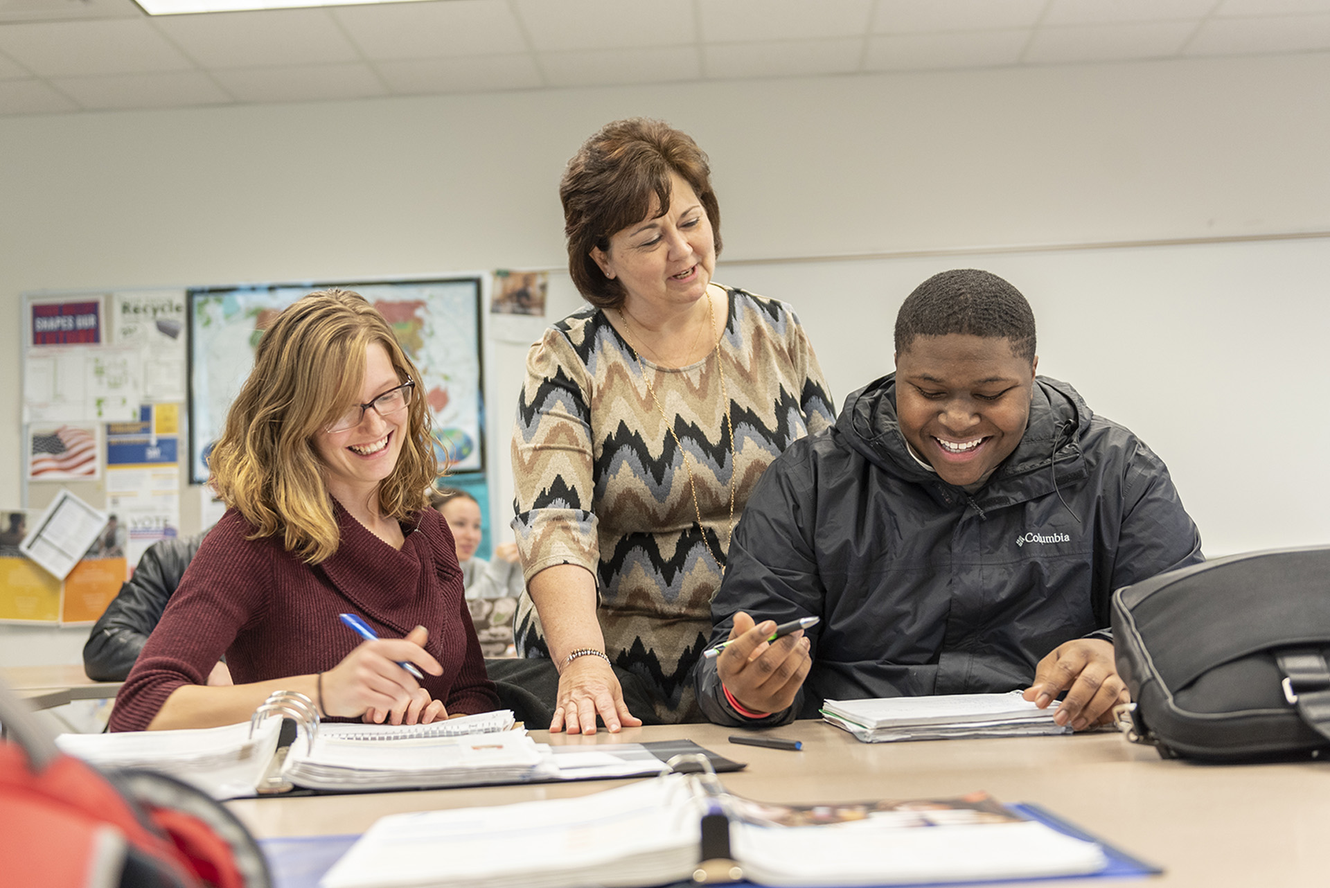 Students working with instructor in accounting class. 