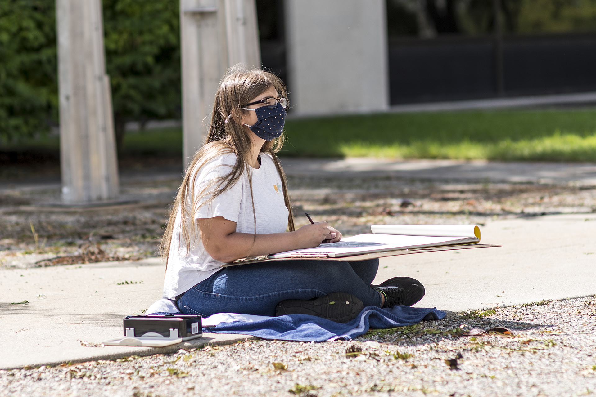 Student drawing outside