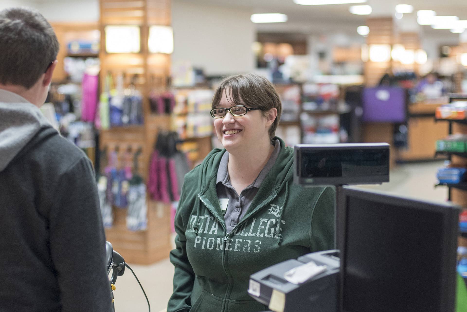 Smiling student at Bookstore counter