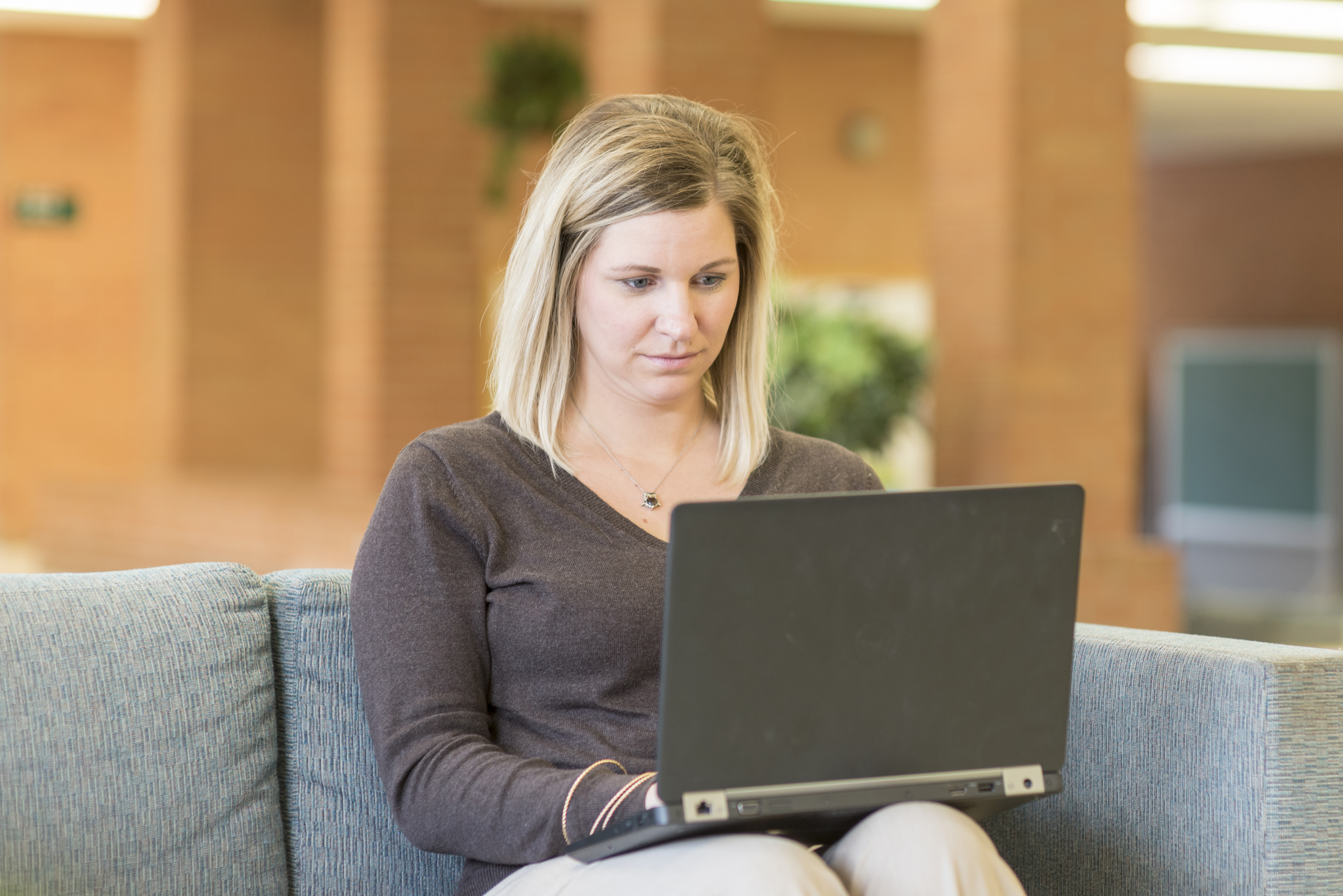 Delta student working on laptop.