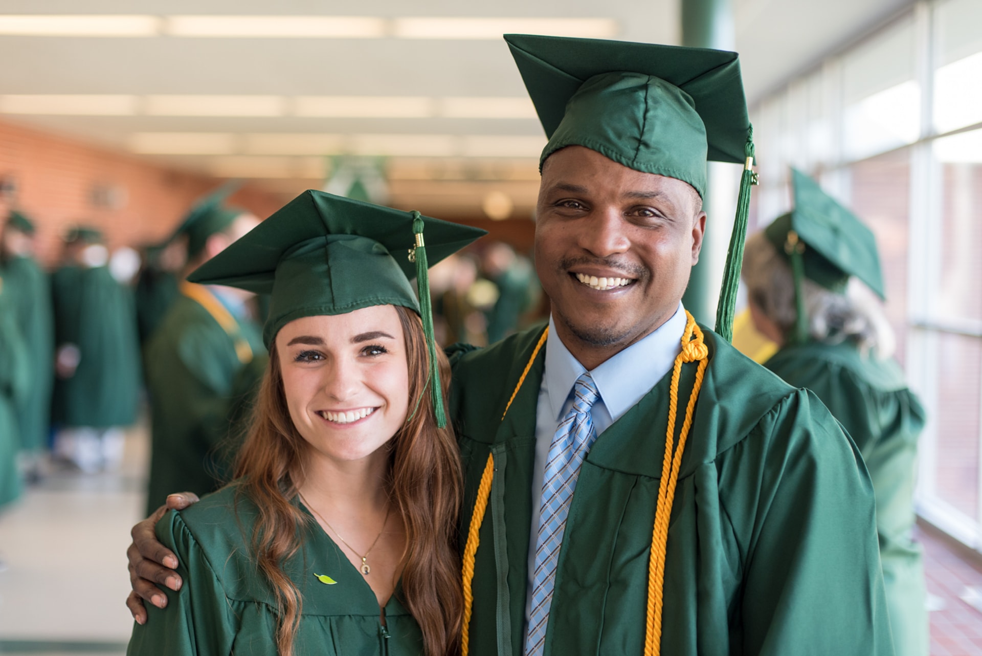 Two students in caps and gowns for graduation