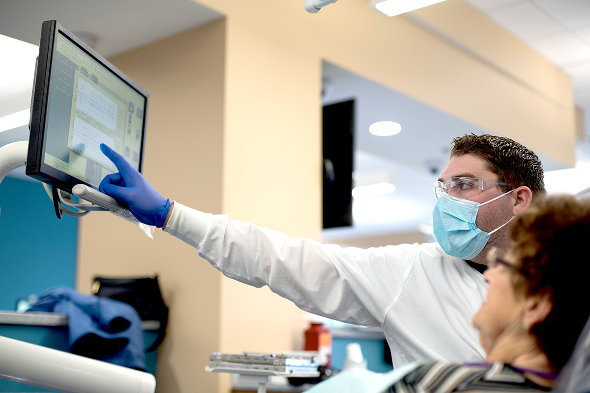 Dental student working in clinic.