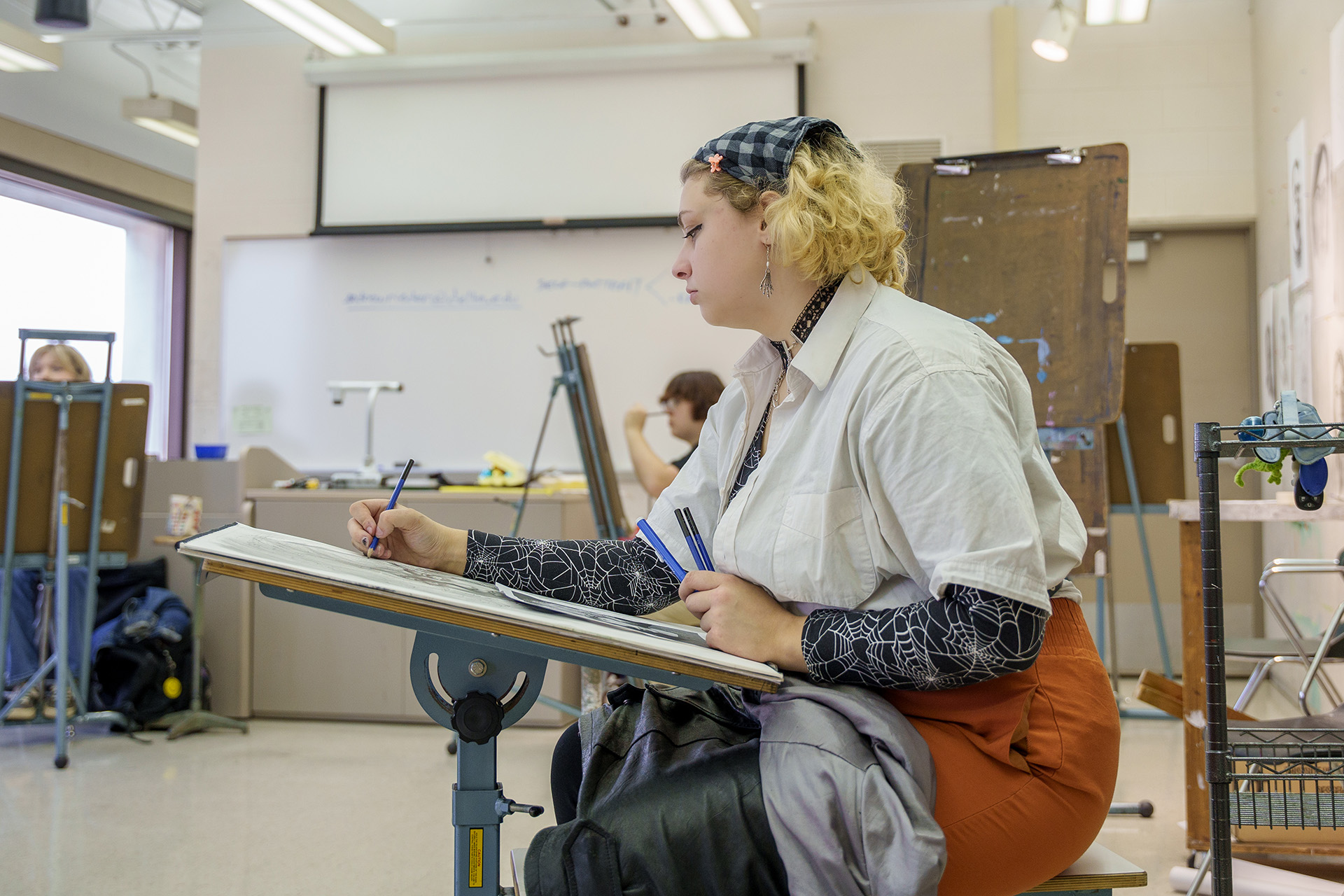 Student drawing in studio