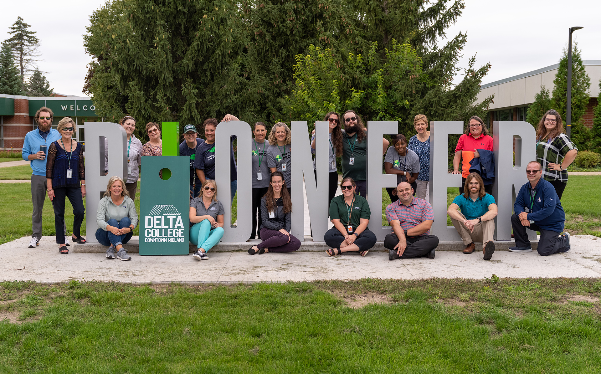 Group of Delta employees outside by PIONEER sign
